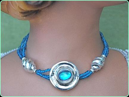 Designer blue and silver choker necklace with large silver disc centre piece with a blue stone
