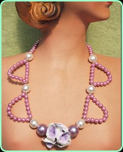 Long pink and purple pearl necklace with pretty pale lilac flower centre