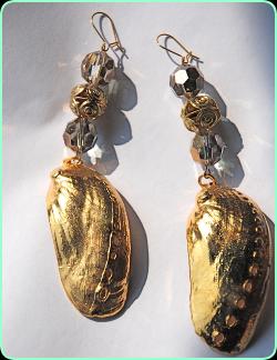 Designer gold colour and glass earrings with a large gold shell drop