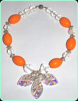 Designer crystal and orange beads with three  large crystals drop